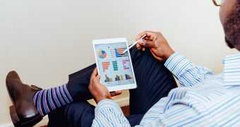 person sitting on chair holding iPad